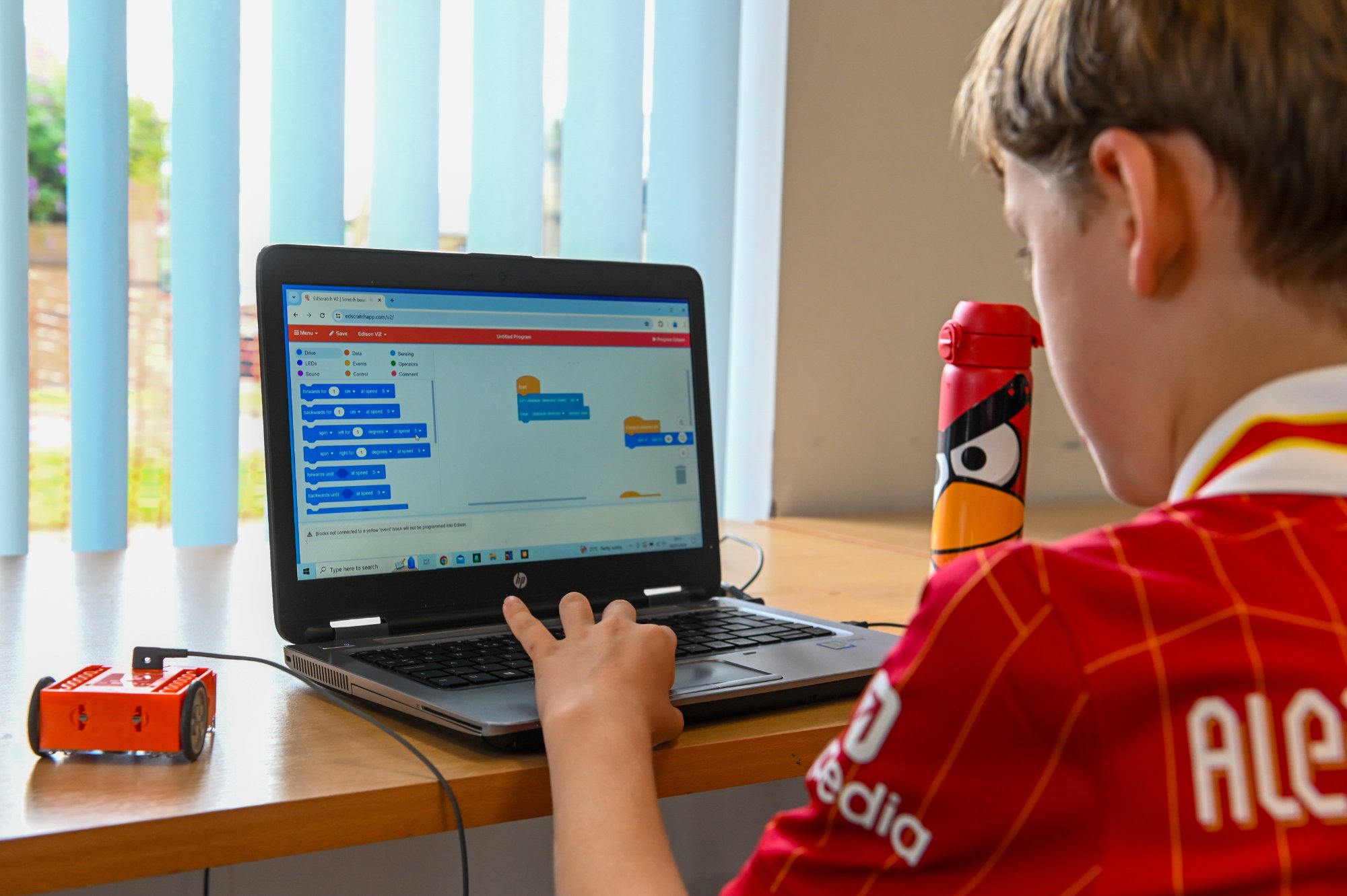 student using an edison robot at a laptop