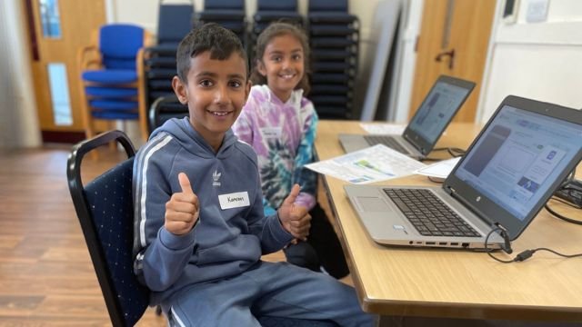 children with thumbs up at holiday camp